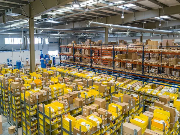 A large warehouse stocked with pallets and boxes, representing wholesale and distribution.